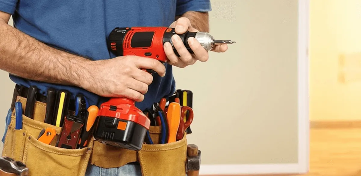 Handyman holding a power drill for home repairs and installations in Albany, NY